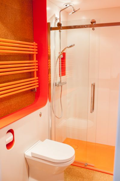 Hi-MACS Ivory White Wall Panels in Orange Bathroom